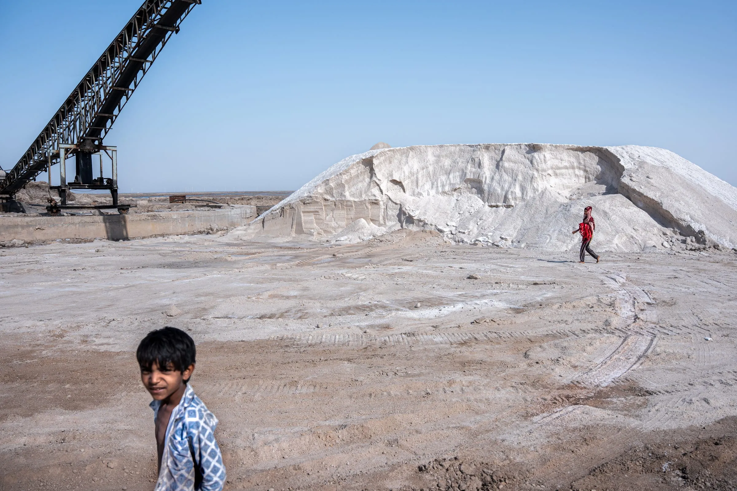 Members of the Agariya community harvest salt in the salt pans of Maliya, within the Little Rann of Kutch, Gujarat, India. Also known as Koli Agariyas, they are traditional salt farmers who migrate seasonally to the Rann, living and working in harsh desert conditions for six to eight months each year. Salt production in this region is believed to date back thousands of years.