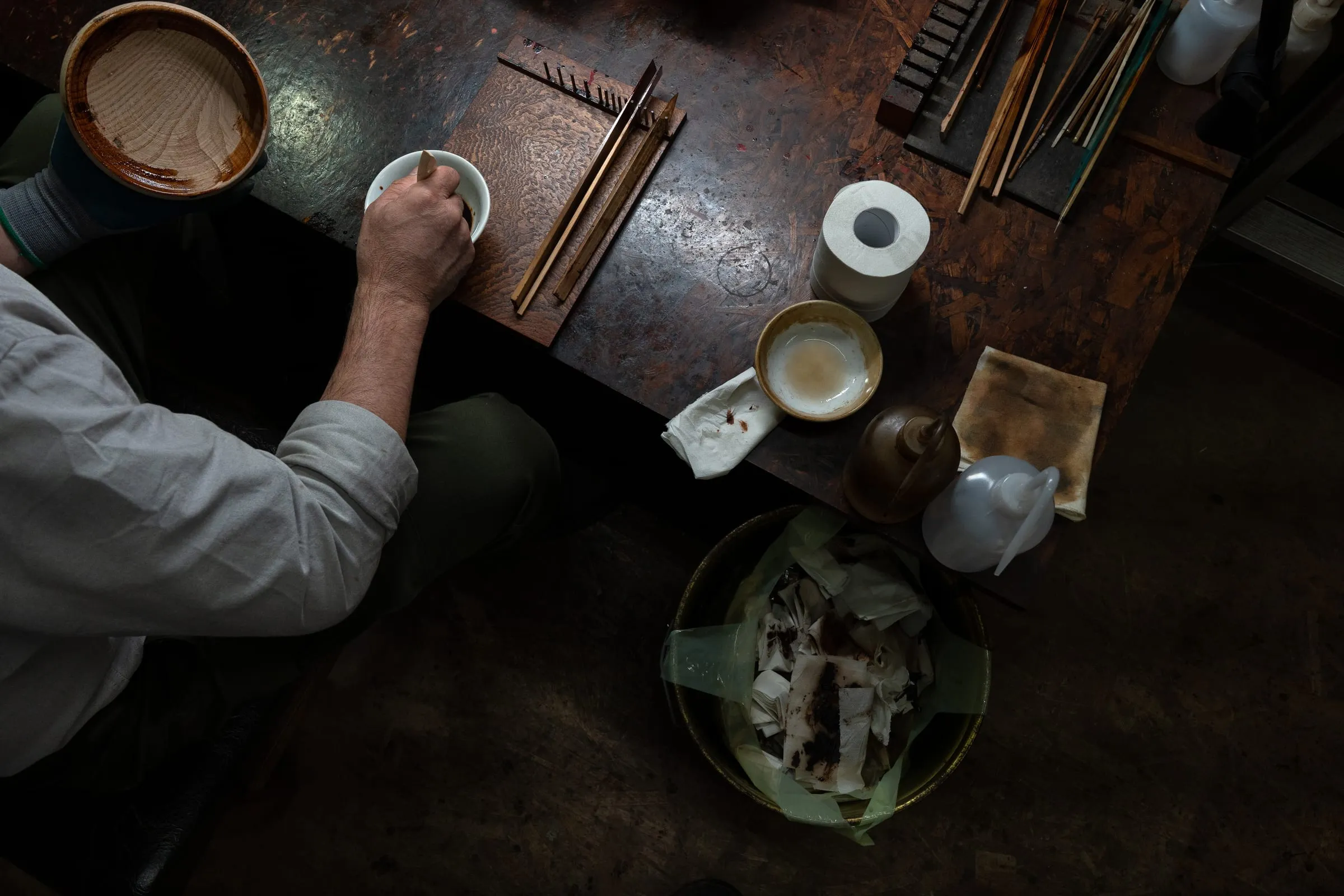 Tsuji Tohru, 61, works on a wooden lacquerware piece in his workshop in Daigo, Ibaraki Prefecture, Japan. He carries out the full cycle of urushi work — from growing lacquer trees and collecting the sap to refining it and applying it to wooden objects for sale. Machines assist in the refining stage, but traditional tools are still used, and most of the process is done by hand to avoid stressing the sap. Tsuji runs a renowned shop in Daigo, where he sells handcrafted wooden bowls and cups finished with natural urushi lacquer.
