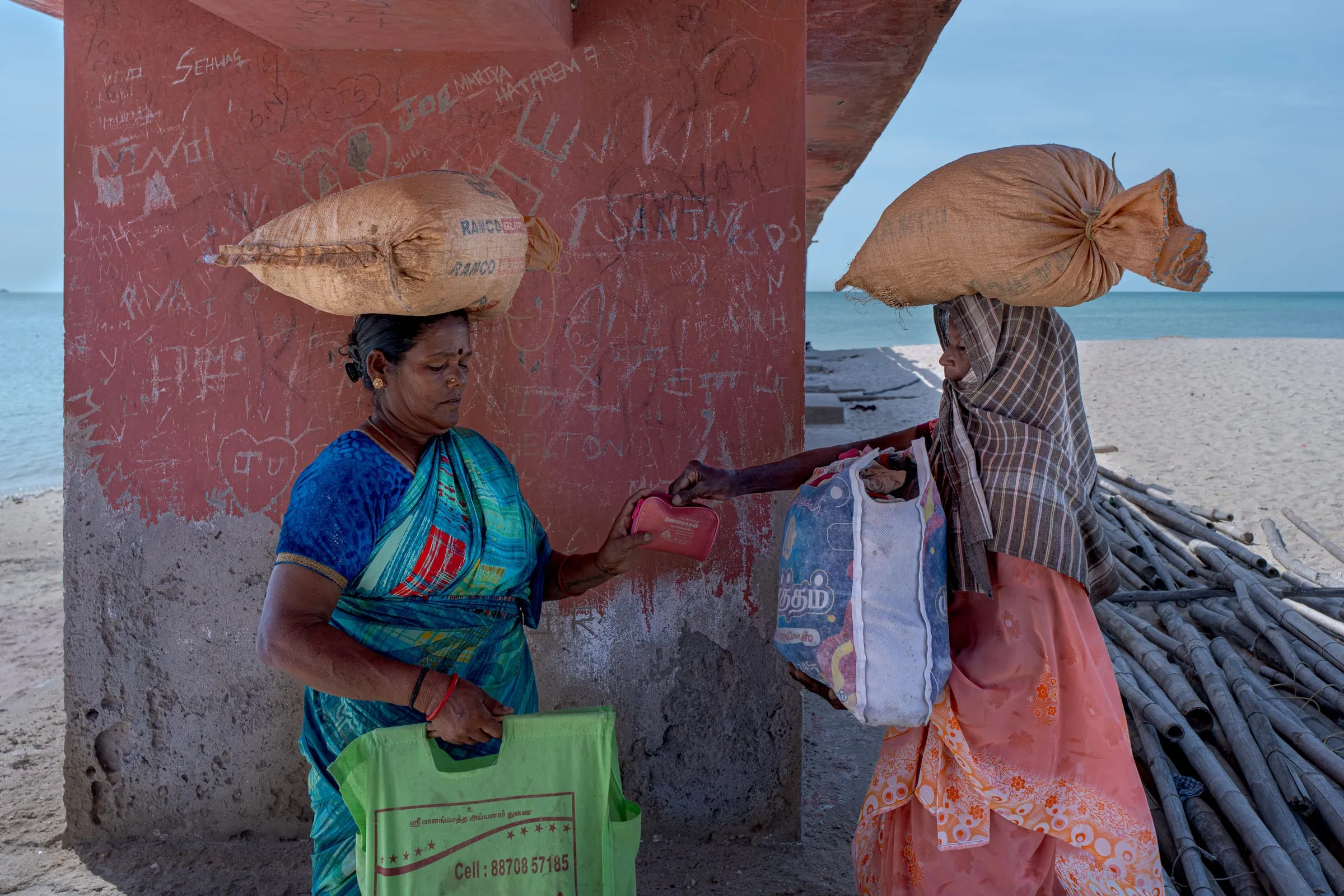 Mary, 57, and Bagvati, 52, finalize a seaweed collection at the shore in Villondi. Most women hand over their harvest to male middlemen who set prices and control sales. Few know the true market value or final buyers of their product. Even basic gear and supplies are purchased through men in their households or local harbor shops.